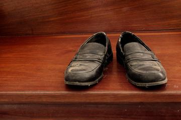 Old shoes on wooden staircase
