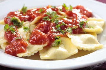 Portion of ravioli with tomato sauce