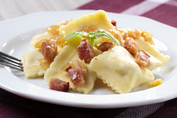 Portion of ravioli with onion and bacon