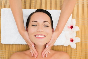 Obraz na płótnie Canvas Smiling brunette enjoying a facial massage