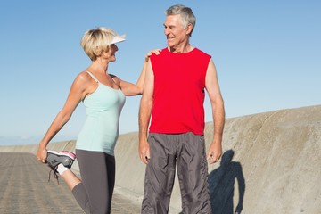Active senior couple stretching before a jog