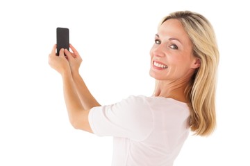 Fototapeta premium Happy blonde sending a text message