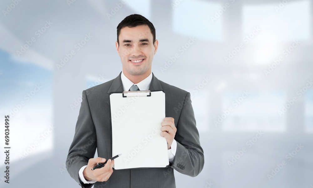 Poster composite image of businessman pointing with pen on clipboard