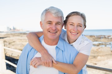 Casual couple having fun by the sea
