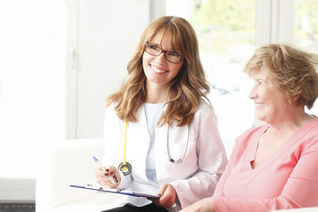 Female doctor with senior patient