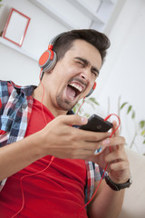 Fototapeta premium Young Man Relaxing Listening To Music At Home