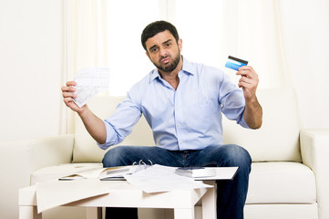latin business man worried paying bills on couch