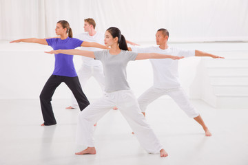 Fototapeta na wymiar Sporty people stretching hands yoga class in fitness studio