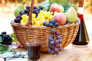Grapes in wicker basket and red wine