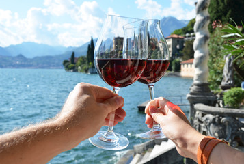 Wineglasses against lake Como, Italy