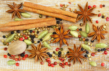 Selection of spices and herbs on wooden surface