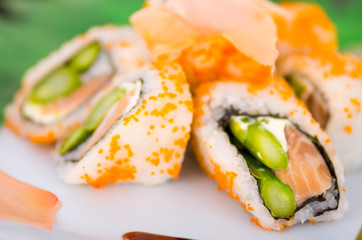 Fresh sushi rolls with asparagus and caviar on a plate