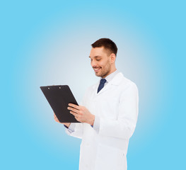 Obraz na płótnie Canvas smiling male doctor with clipboard