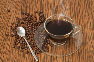 Coffee cup and coffee beans on old wooden background