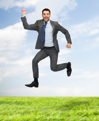 smiling happy businessman jumping