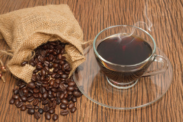 Coffee cup and coffee beans on old wooden background