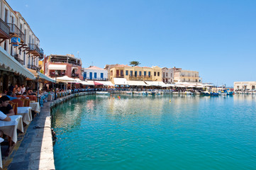Fototapeta na wymiar The venetian harbour with bars and restaurants. Crete, Greece.