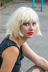 Naklejka premium Portrait of young blonde woman with bright make-up giddy