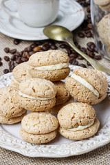 Cup of coffee and stack of french cakes