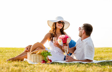 smiling couple drinking champagne on picnic