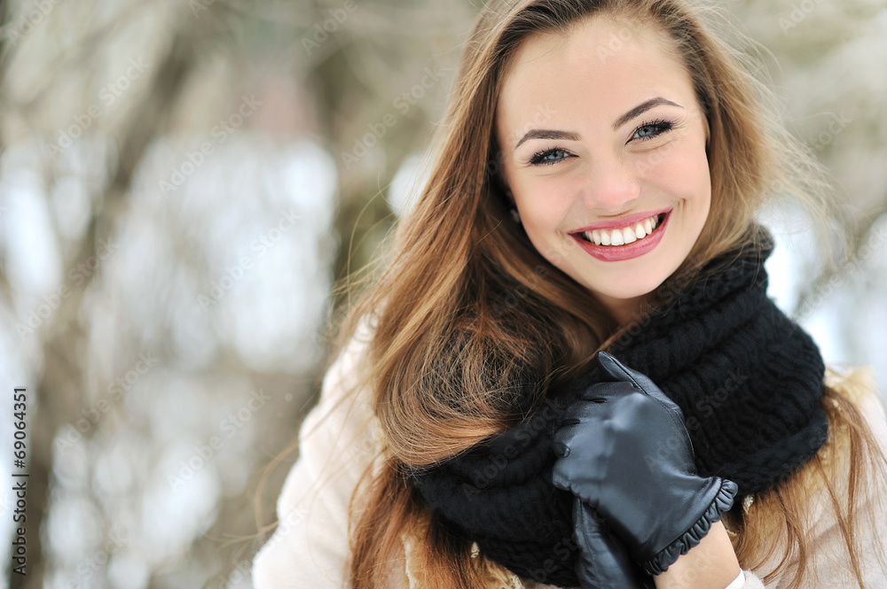 Wall mural Beautiful smiling woman face outdoor portrait