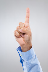 Businessman hand gesture show number one