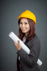 Asian engineer girl hold a blueprint and smile