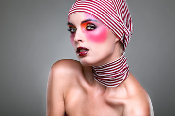 girl with a bright make-up with the striped scarf on a head