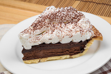 Chocolate Tart with cream and cocoa powder on the top