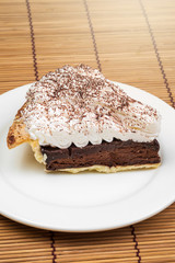 Chocolate Tart with cream and cocoa powder on the top