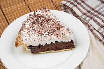 Chocolate Tart with cream and cocoa powder on the top