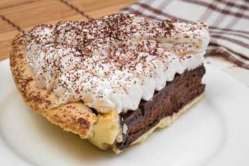 Chocolate Tart with cream and cocoa powder on the top