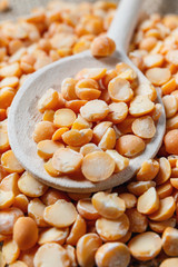  dry peas on a wooden spoon, close up