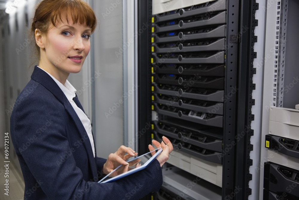 Aufkleber Pretty technician using tablet pc while working on servers