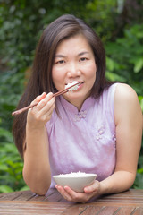 woman eating rice