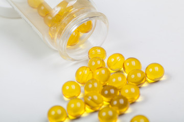 Pills from bottle on the white background.