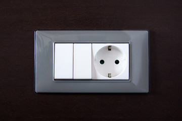 wooden wall with power outlet and light switch
