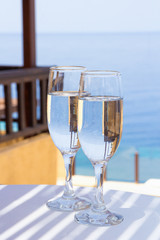 glasses of champagne on terrace with sea view