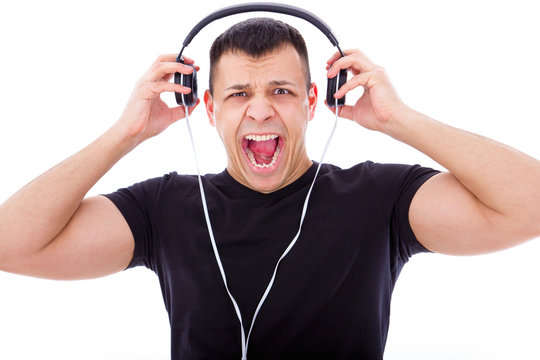 angry man yelling listening to loud music with headphones