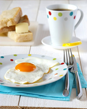 Traditional breakfast of fried egg, bread and butter