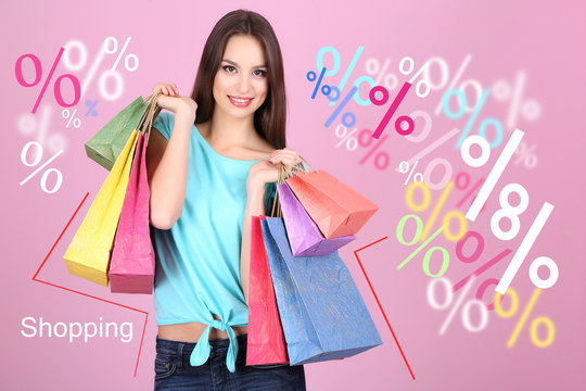 Shopping time. Beautiful young woman with bags