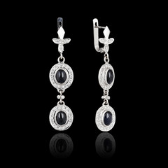 White gold earrings isolated on black background
