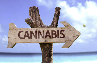 Cannabis wooden sign with a beach on background