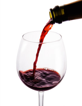 Pouring red wine.beautiful glass.isolated with clipping path.