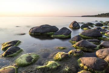 rocky beach at sunset with milky water