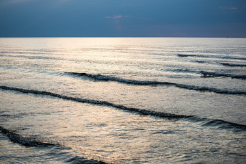 sea with waves before sunset