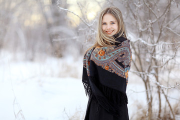 Beautiful Russian woman in a scarf in winter
