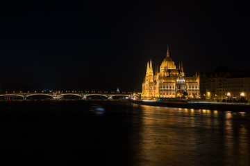 Fototapeta na wymiar Nighttime river view of the parliament building in Budapest Hung