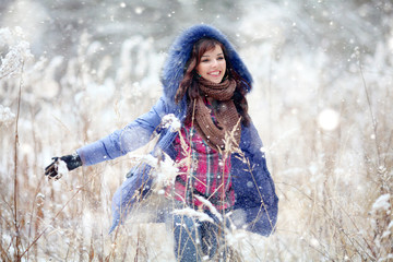 Girl having fun and jumping in the snow