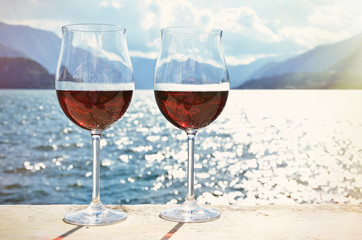 Two wineglasses against lake Como, Italy
